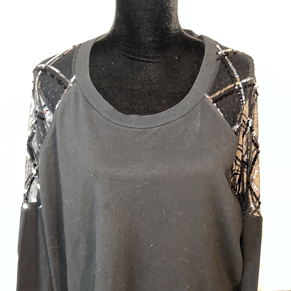 Size 24 ladies black crew neck long sleeve top. Netting and sequins on arm.